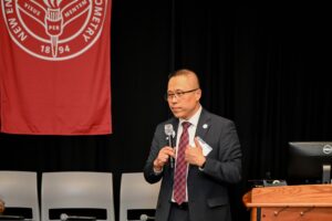 Dr. Gary Chu at the front of the lecture hall talking on health equity