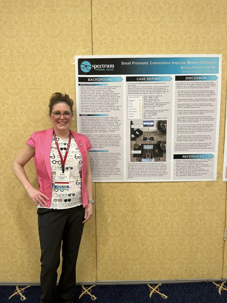 Dr. Melissa Richard in front of a poster she's presenting