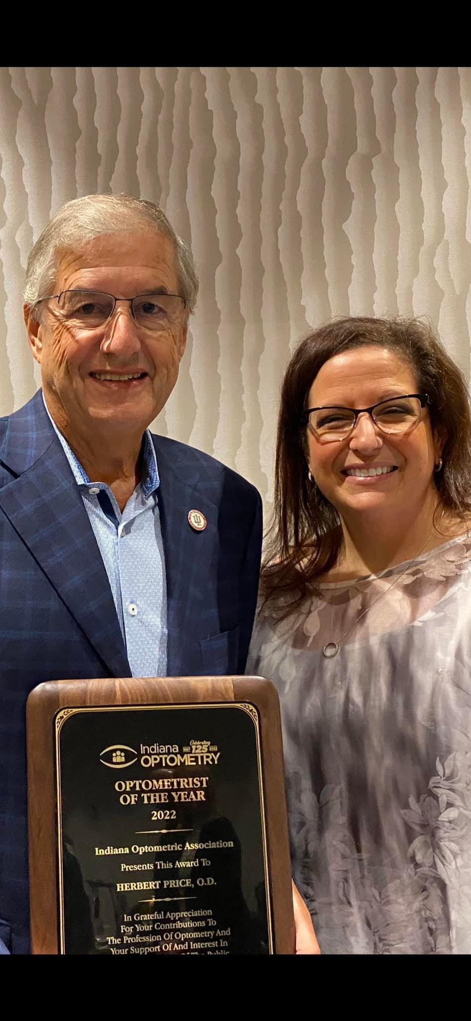 Dr. Herbert Price with his daughter Dr. Monica Price Kowaleski - he is holding his optometrist of the year plague from the Indiana Optometric Association