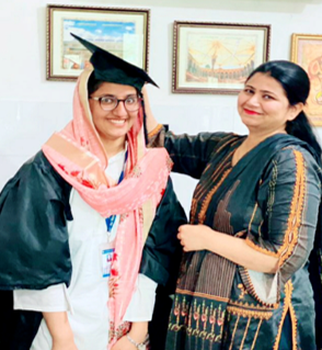Dr. Jabbar receives her graduation cap from Research Supervisor Dr. Ayesha Kiran