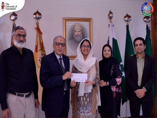 Dr. Jabbar (center) receives a Letter of Appreciation from Prof. (Meritorious and Tenured) Dr. Muhammad Khaleeq-Ur-Rehman and Madam Zahida Maqbool Registrar TUF
